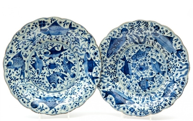 Two large blue and white lobed chargers, crab and fish