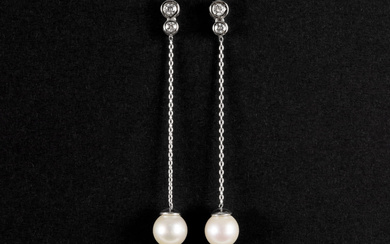 pair of quite long earrings in white gol