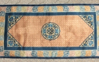 A CHINESE WOOL RUG with central motif and patterned