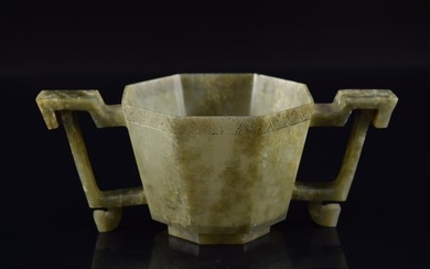 17th century Chinese celadon jade octagonal paneled 2-handle cup. Carved diaper top border. 5.75in