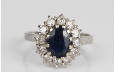 18ct white gold diamond and sapphire cluster ring, the centr...