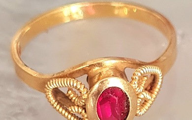 18k gold ring by UNOAERRE, with oval ruby at...