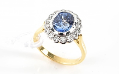 A SAPPHIRE AND DIAMOND CLUSTER RING IN TWO TONE 18CT GOLD