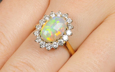 An 18ct gold oval opal cabochon and diamond cluster