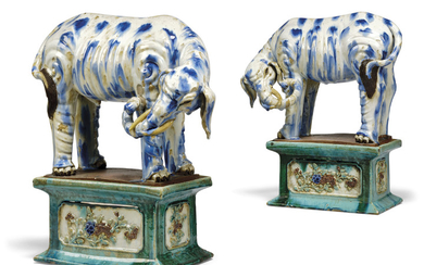 A PAIR OF CHINESE BLUE AND WHITE AND POLYCHROME-GLAZED STONEWARE LARGE ELEPHANTS ON STANDS, 18TH/19TH CENTURY, GUANGDONG WARE
