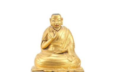A gilt-bronze figure of a seated Lama