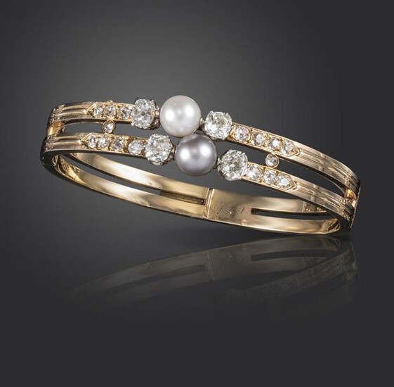 A 19th century French natural pearl and diamond bangle, set with a white pearl and a grey natural pearl, old cushion-shaped diamonds and further old circular-cut diamonds to the shoulders in gold, French control mark, 5.2cm wide Accompanied by report...