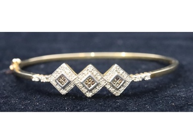 A 9ct gold ladies hinged bangle with 3 centre triangles, ins...