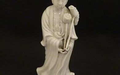 A Chinese blanc de chine figure of Guanyin holding