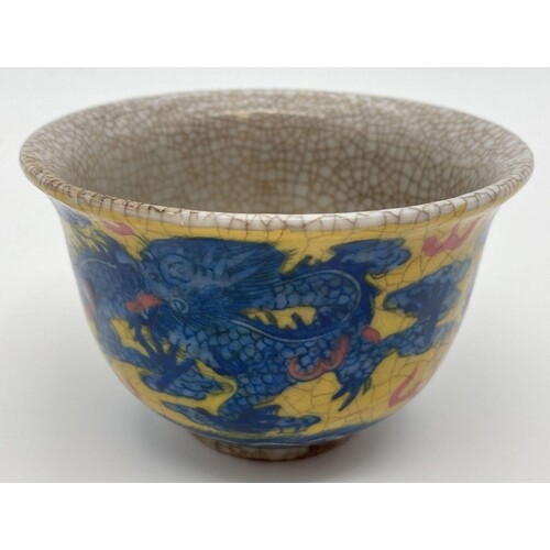 A Chinese crackle glaze ceramic tea bowl. Yellow ground with...