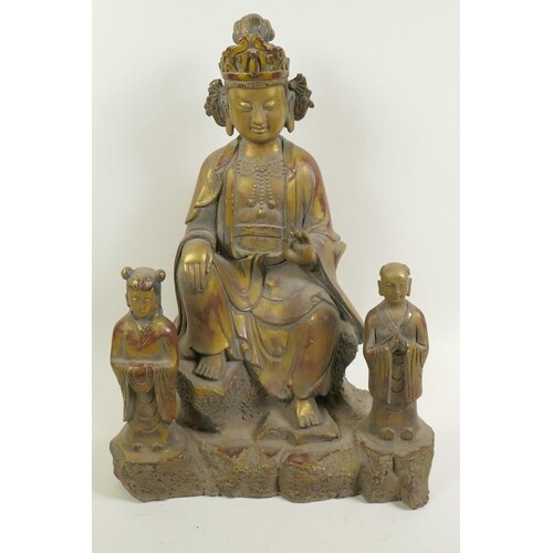 A Chinese gilt bronze figure of a seated deity accompanied b...