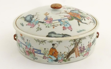 A Chinese lidded pot decorated with figures in a garden
