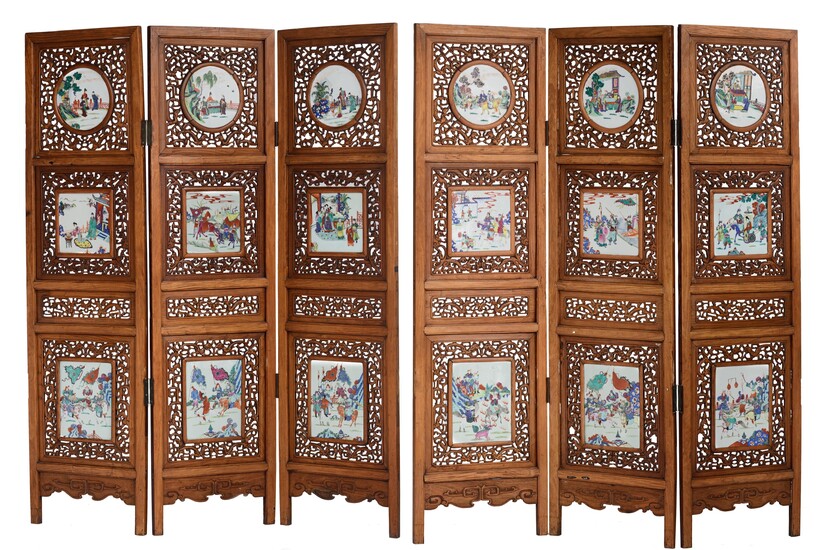 A Chinese openwork carved exotic hardwood six-panel screen, the circular and rectangular famille rose porcelain...