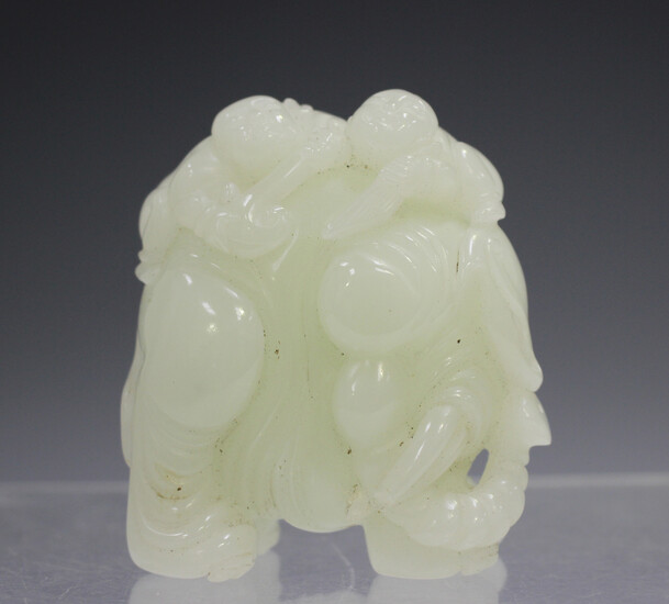 A Chinese pale celadon/white jade carving of an elephant, probably 20th century, modelled with a pro
