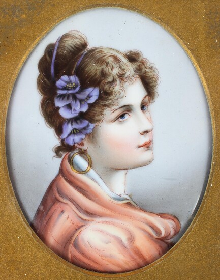 A Continental porcelain oval portrait plaque of a young lady, late 19th century, in glazed frame