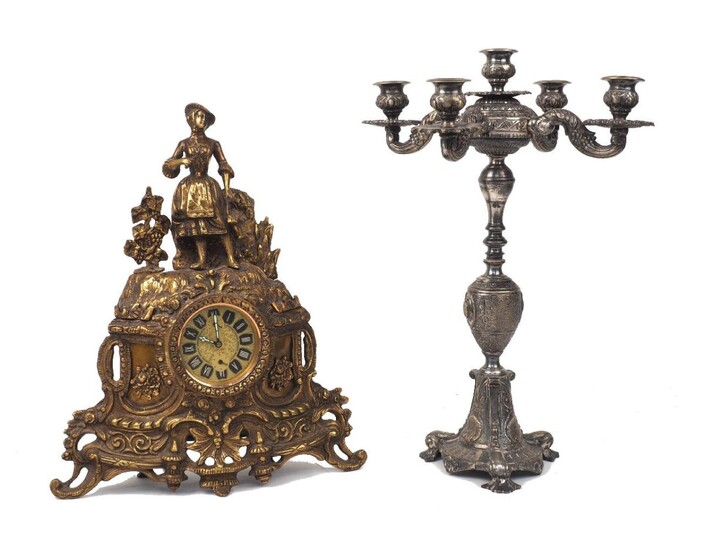 A French gilt bronze mantel clock surmounted by a lady, 20th century, the circular dial with Roman numerals, two sub-dials, signed 'Peter', with later movement, 39cm high, together with; a silvered bronze five light candelabra, with scrolling...
