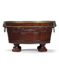 A GEORGE III ORMOLU-MOUNTED MAHOGANY OVAL WINE-COOLER, AFTER A DESIGN BY ROBERT ADAM, ATTRIBUTED TO SEFFERIN NELSON, CIRCA 1772-4