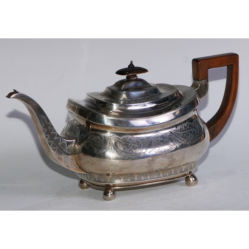 A George III silver boat shaped teapot, bright-cut and wrigg...