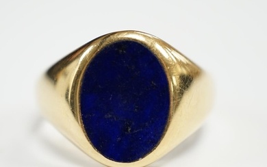 A George V 18ct gold and oval lapis lazuli set signet ring, ...