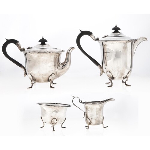 A George V four-piece silver tea service, on hoof feet, lidd...