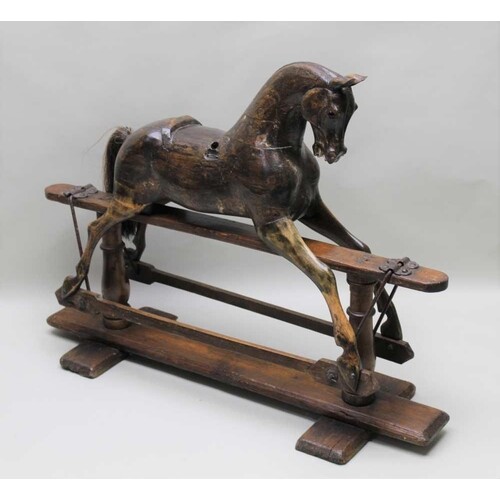 A LATE 19TH CENTURY CARVED WOODEN ROCKING HORSE with real ha...