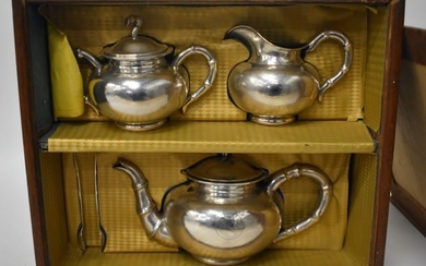 A LOVELY 19TH CENTURY CHINESE HAMMERED SILVER THREE PIECE SILVER TEASET by Hung Chong & Co, together