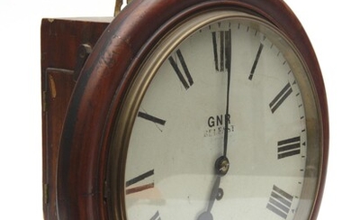 A MAHOGANY CASED ENGLISH FUSÉE DIAL CLOCK FOR THE GREAT NORTHERN RAILWAY (IRELAND), WITH AN ENAMELLED ROMAN NUMERAL DIAL SIGNED 'GNR..