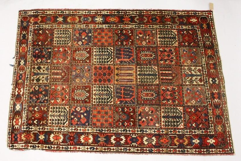 A PERSIAN RUG, 20TH CENTURY, the central field with