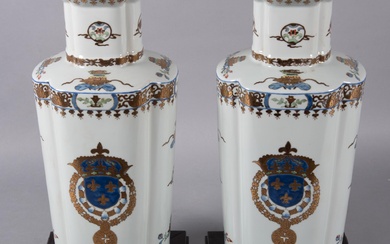 A Pair of Continental Porcelain Urns with Shield-Form Fleur de Lys Gilt Highlights.