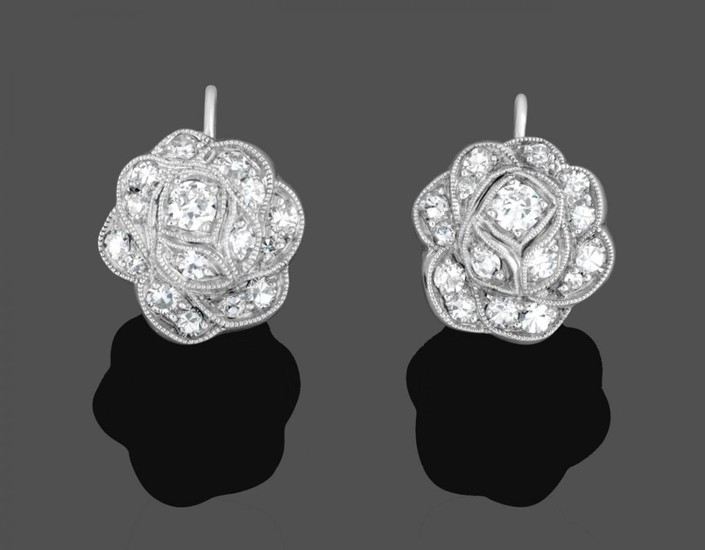 A Pair of Diamond Cluster Earrings, the floral motifs set...