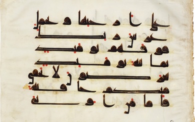 A Qur'an leaf in Kufic script on vellum, North Africa...