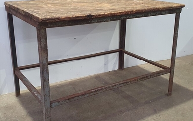 A RUSTIC WORK TABLE ON METAL BASE