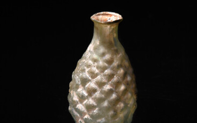 A Roman pale green glass pine cone flask