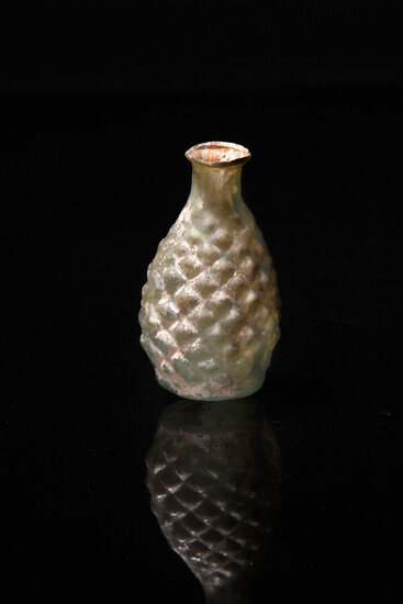 A Roman pale green glass pine cone flask