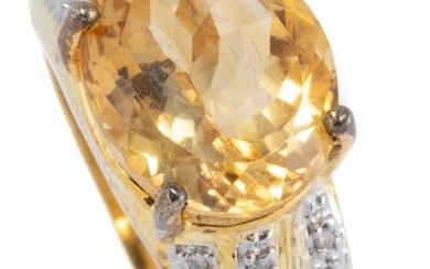 A SILVER GILT CITRINE AND DIAMOND RING; claw set with an oval cut citrine of approx. 4.70ct, above tapered shoulders set with single...