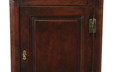 A SMALL 18TH CENTURY PANELLED OAK HANGING CORNER CUPBOARD...