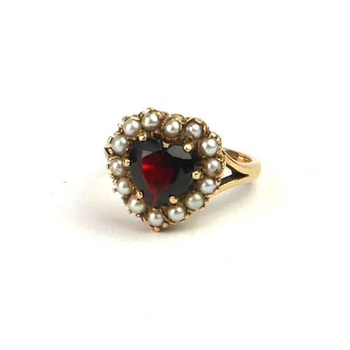 A VINTAGE 9CT GOLD, GARNET AND SEED PEARL RING Having a hear...