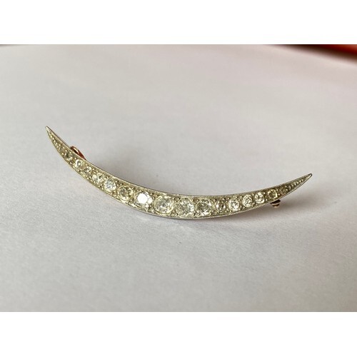 A Victorian diamond set crescent brooch, set with graduated ...