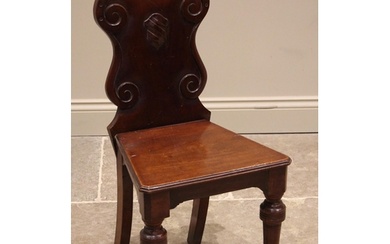 A Victorian mahogany hall chair, the shaped back with scroll...
