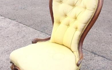 A Victorian mahogany upholstered spoonback chair with buttoned back above...