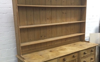 A Victorian pine dresser with later delft rack, the moulded...