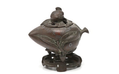 A bronze incense burner with stand in the shape of peach