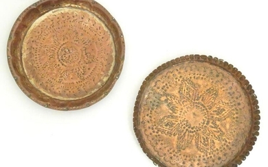 A copper dish of circular form with punchwork and