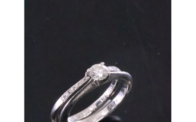 A diamond solitaire ring set in platinum with a diamond set ...