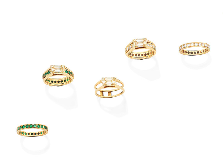 A fancy coloured diamond ring, a diamond eternity ring, and an emerald eternity ring