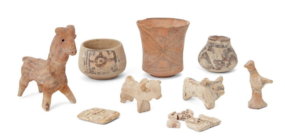 A group of Proto-Indus valley animal figures, comprising a three slip-painted vessels, a model of a ram, two sheep, a bird, and two rectangular carved bone buttons (one fragmentary), ram 9.7cm. high (9) Provenance: Private London Collection formed...