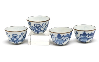 A group of blue and white porcelain teacups painted with precious objects