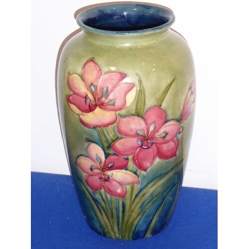 A large Moorcroft pottery vase decorated with red lilies; p...