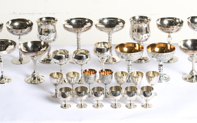 A large silver-tone drinkware assortment in a variety of designs,...