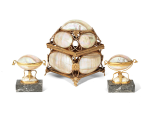 A late 19th / early 20th century French Palais Royal style gilt metal mounted mother of pearl shell scent bottle casket together with a pair of similar period gilt metal mounted mother of pearl shell trinket box ornaments